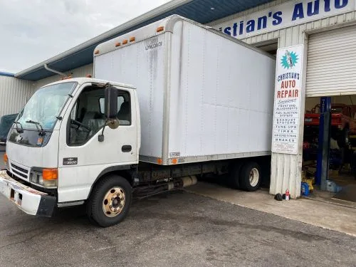 A white box truck in for service