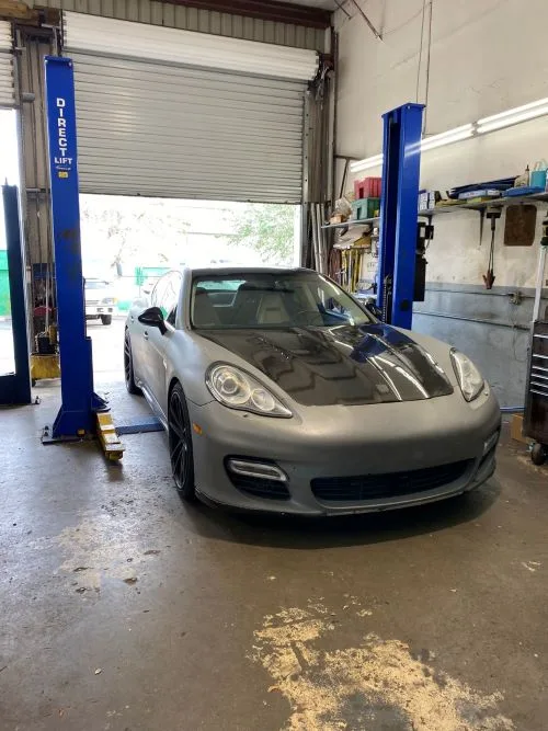 A Porsche Panamera pulled into the service bay